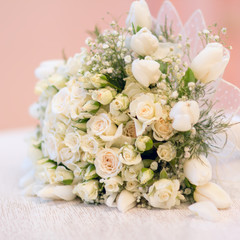 The bride's bouquet, white roses, tulips, delicate flowers, use as background or texture, soft pastel colors