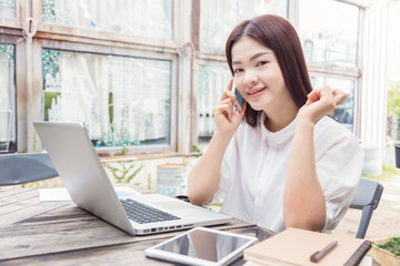 young happy casual asian woman using technology on her laptop co