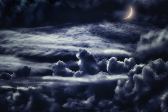 dreamy cloudscape at night with moonlight