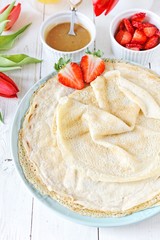 Coconut pancakes with strawberries and caramel