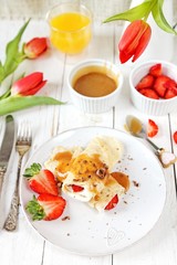 Fototapeta na wymiar Coconut pancakes with strawberries and caramel