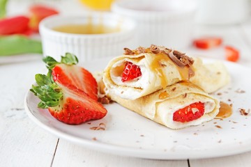 Coconut pancakes with strawberries and caramel