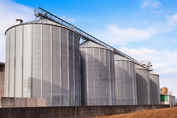 Fototapeta na wymiar Agricultural silos on blue sky.