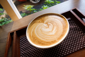 Latte bowl with tulip art on a wooden tray