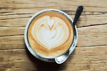Latte art on wooden table