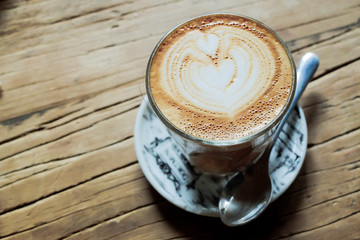 Latte art on wooden table