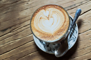 Latte art on wooden table