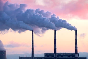 Thermal power plant in the cold winter landscape. Pipe with smok