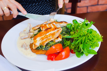 Delicious chicken with spinach and potato pancakes