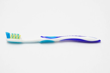 Blue tooth brush on isolated white background. Healthy lifestyle concept.