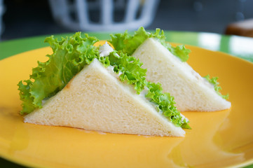 Tuna sandwich on yellow plate