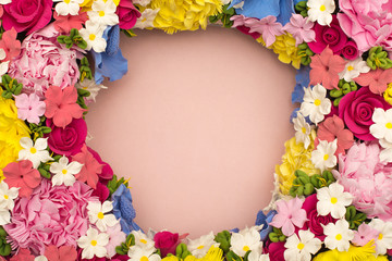 Pink background with red, pink, white, purple flowers in a circle. Postcard for the holiday (Mother's Day, Easter, birthday, congratulations, Valentine's Day). Place for writing (letters). mock up