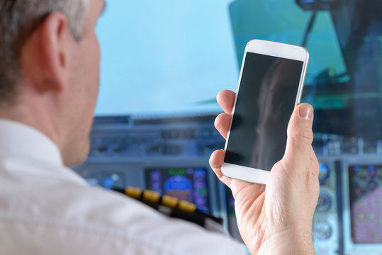 Airline pilot using smart phone