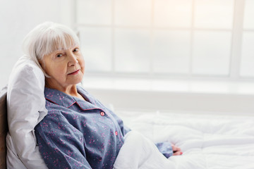 Naklejka premium Serene grandmother resting in hospital office