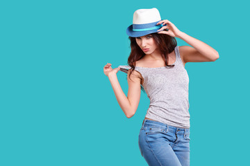 Young Woman with spring hat against blue background