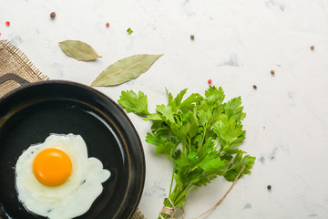 Morning in the kitchen. Cooking breakfast. Fried egg. Light background
