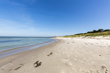 two teenager at an empty beach in summer