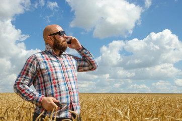 Hairless man with beard in glasses smoke electronic cigarette. outdoor banner blue sky w clouds background.