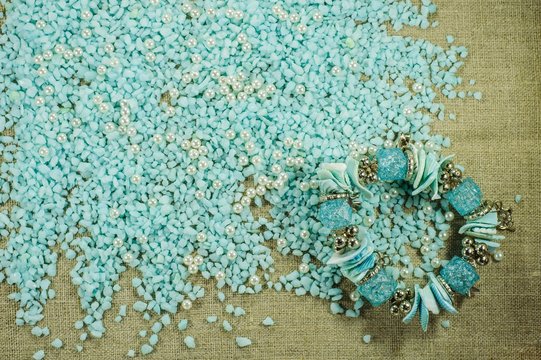 Blue bracelet with shells on the scattered blue gravel with pearl beads.