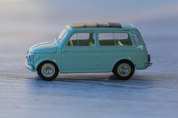 Metal model of mini car, old toy close-up.