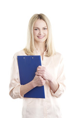 Businesswoman at isolated background. Shot of a smiling middle aged woman holding clipboard in her hands while standing against white background.