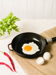 Morning in the kitchen. Cooking breakfast. Fried egg.