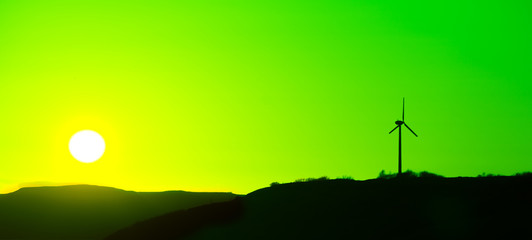 Wind Turbine at a green sunset