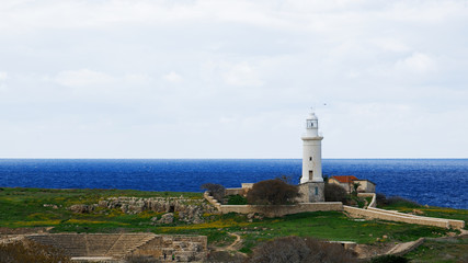 Fototapeta na wymiar Lighthouse stands over the sea in Paphos, Cyprus