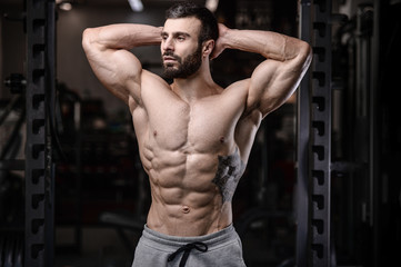 Fototapeta na wymiar Handsome fitness model train in the gym gain muscle.