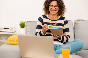 Fototapeta premium Beautiful woman eating a salad