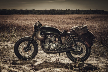Vintage custom motorcycles in field
