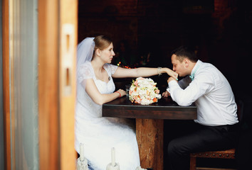 The lovely couple in love sitting in restaurant