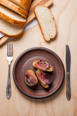 Baked potatoes with slices of bacon on wooden background. Slices