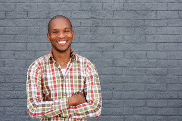 smiling african american man standing against gray background