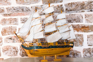 Miniature ship over brick background in museum near Budva, Montenegro, wooden replica of the old...