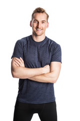 Blonde man wearing workout clothing standing against a white background staring at camera.