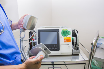 doctor use ekg defibrillators monitor in emergency room
