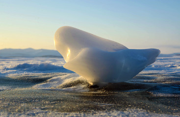 Small piece of ice on lake Baikal at sunrise