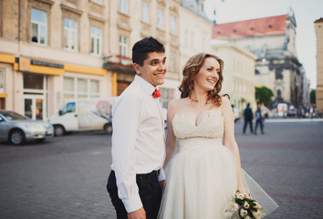 The lovely couple in love embracing in the center of town