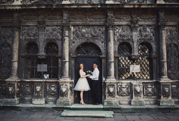 The couple in love holds hands near building