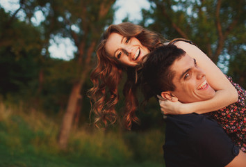 Fototapeta premium The boy carries on hands his girlfriend