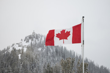 Canadian flag flutters in the wind on top of Sulpher Mountain in