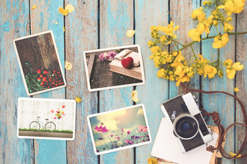 Retro camera and instant paper photo album of valentine day on wood table - photo of remembrance and nostalgia in spring. vintage style