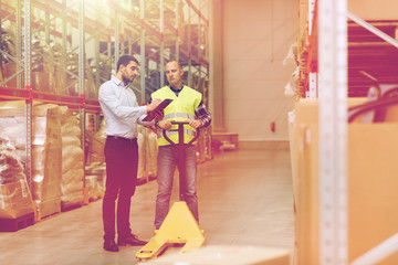 worker and businessmen with clipboard at warehouse