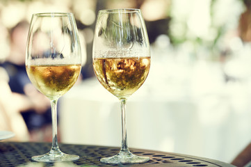 two glasses of white whine outdoors