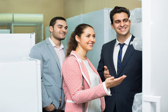 Successful  Seller And Happy  Couple At Household Appliances Sec