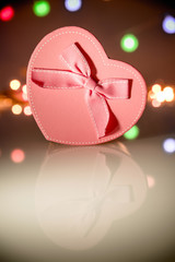     gift box in the form of heart on the background illumination