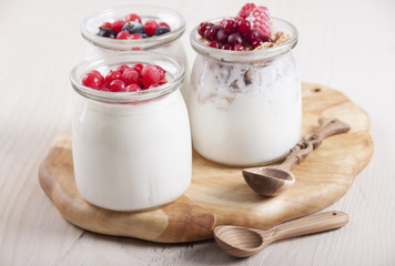 Homemade yogurt with berries in three banks