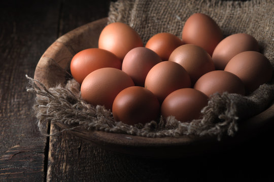Chicken eggs in the wooden bowl horizontal