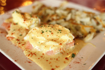 Salmon Eggs Benedict with potato hash.